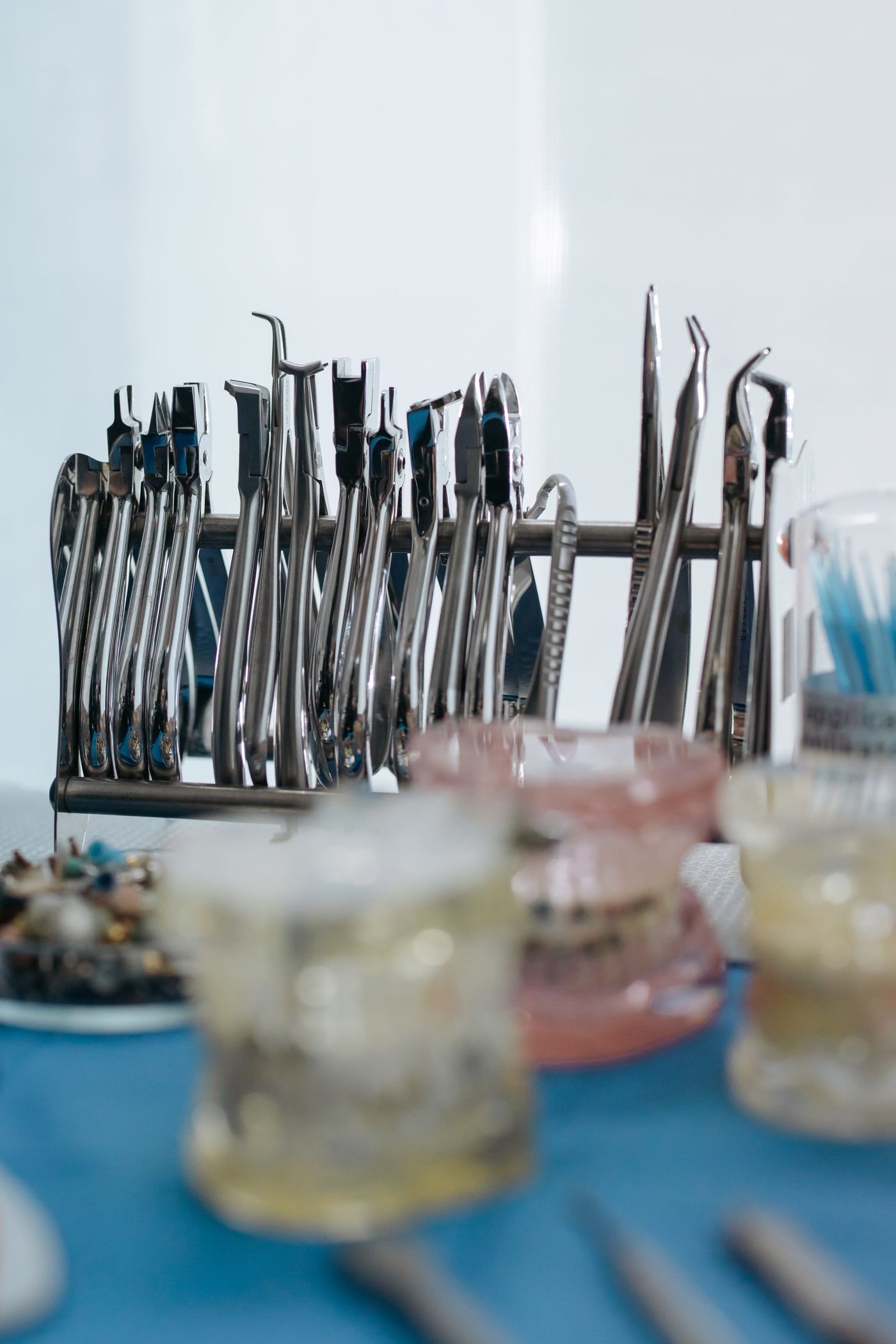Racks of sterilised dental hand instruments and model teeth