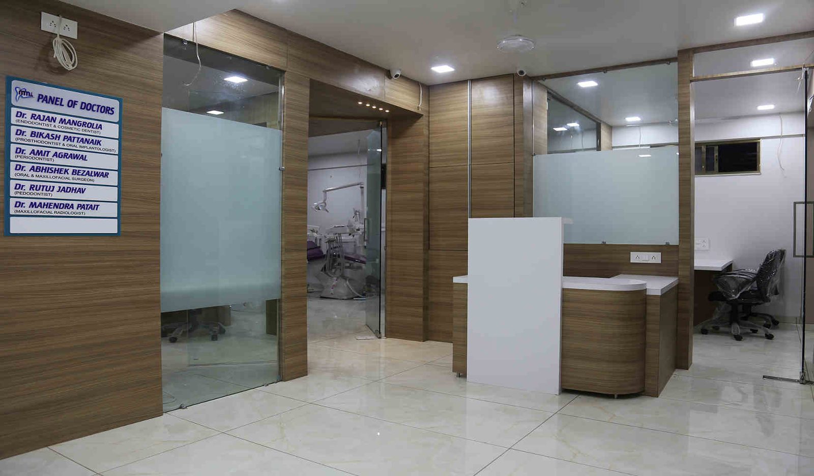 The reception and panel of doctors board at Mangrolia's Multispeciality Dental Clinic